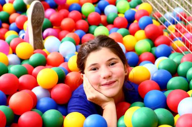 teen beautiful girl in color balls pool clipart
