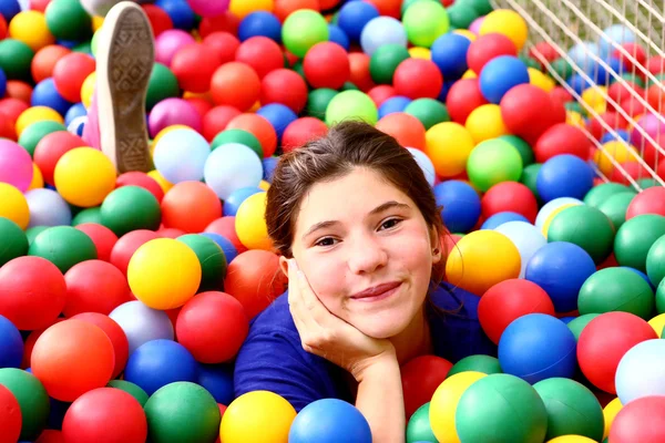 Teen beautiful girl in color balls pool — Stock Photo, Image