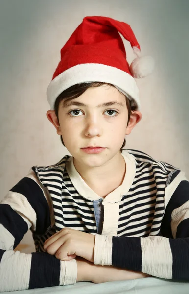 Close up portrait of a preteen boy in santa hat — Stock Photo, Image