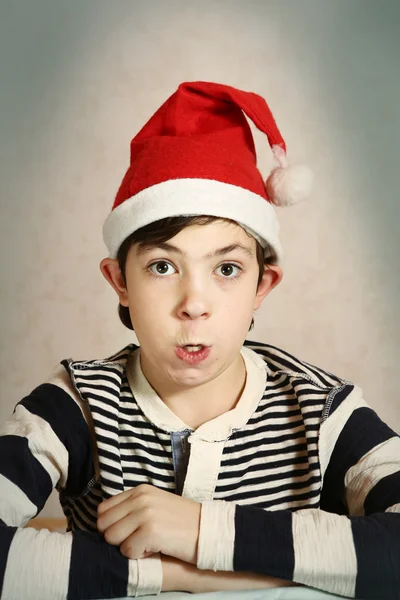 Close up portrait of a preteen boy in santa hat — Stock Photo, Image