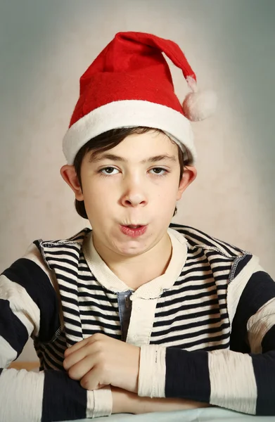 Close up portrait of a preteen boy in santa hat — Stock Photo, Image