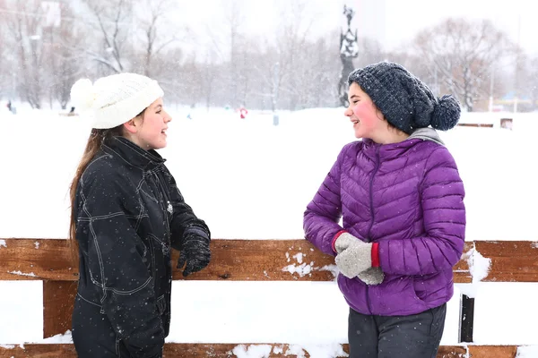 Two teenager girl on the snowy white background — Stock Photo, Image