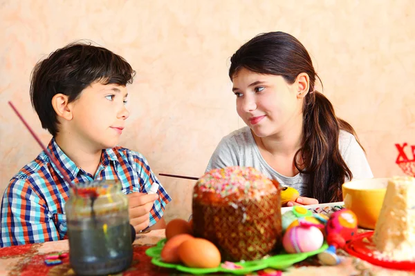 Boy  easter paint eggs and decorate cake — Stock Photo, Image