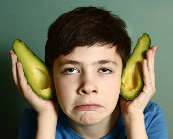 Cute preteen boy performing elf with avocado half — Stock Photo, Image