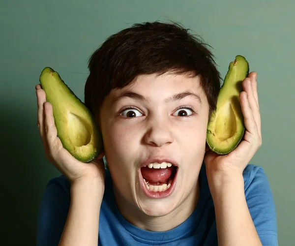 Cute preteen boy performing elf with avocado half — Stock Photo, Image