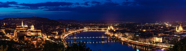 Night Budapest, Parliament against the background of the night city, reflection of lights in the river, panorama of the city