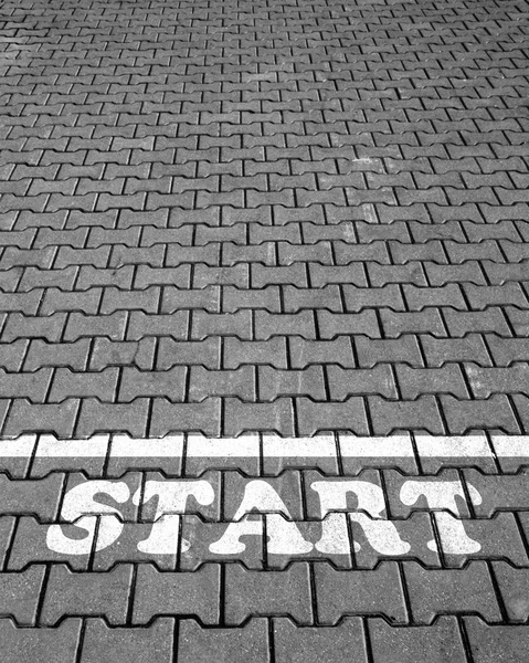 Road tile with a white inscription start — Stock Photo, Image