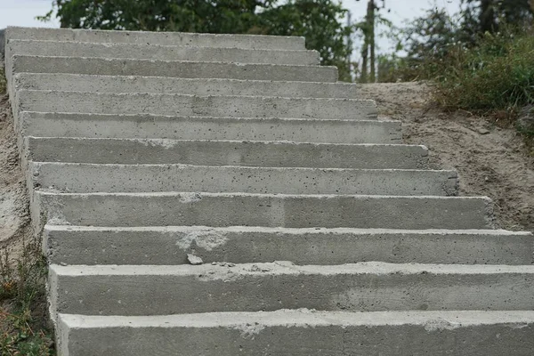 gray concrete steps on a long stone staircase on the street