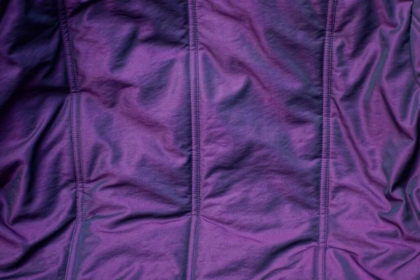 ed lilac texture of fabric from a piece of synthetic with a seams