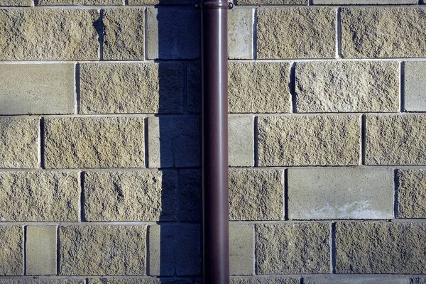 One Brown Plastic Gutter Pipe Brick Wall — Stock Photo, Image