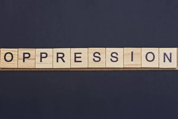 Text Word Oppression Gray Wooden Letters Black Background — Stock Photo, Image