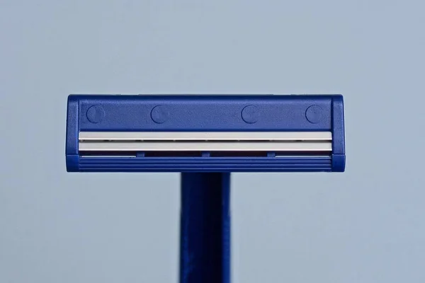 One Blue Plastic Razor Lies Gray Background — Stok fotoğraf