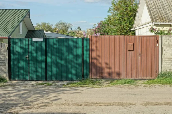 Two Closed Private Gates Green Brown Metal Street Gray Road — Stock Photo, Image