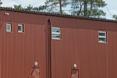  Kahverengi metalden yapılmış, mavi gökyüzüne bakan büyük bir ev. 