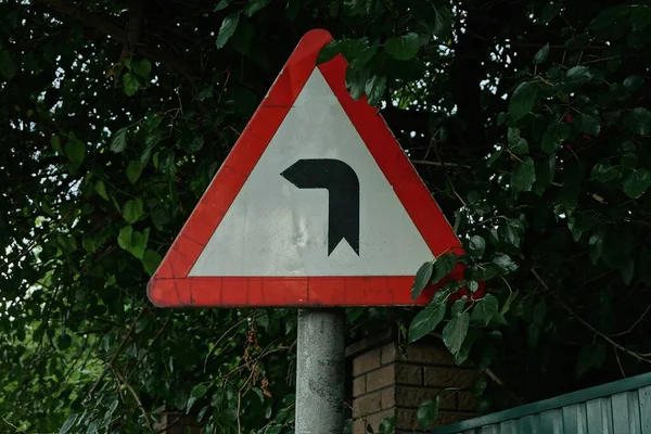 One Triangular Road Sign Dangerous Turn Road Pole Street Green — Stock Photo, Image