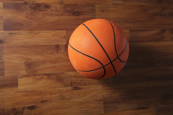 Basketbalový míč přes dřevěné podlahy — Stock fotografie