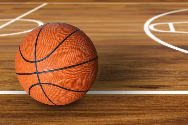 Pallone da basket sul campo da basket in legno duro — Foto Stock