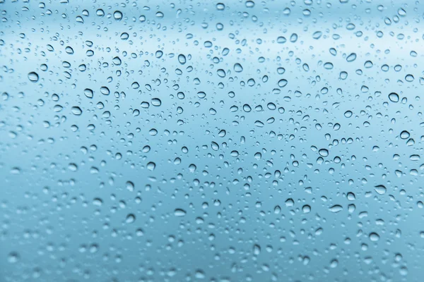 Gotas de chuva no fundo de vidro — Fotografia de Stock