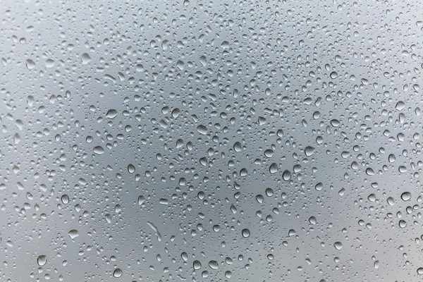 Gotas de chuva no fundo de vidro — Fotografia de Stock