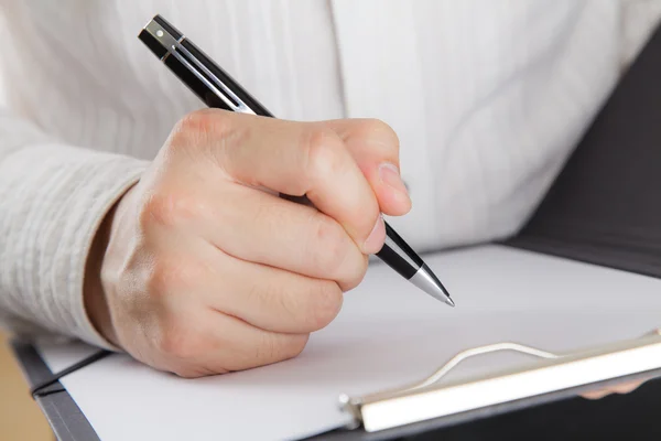 Businessman signing a document Royalty Free Stock Photos