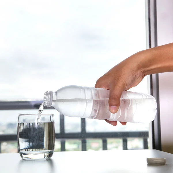 Pouring water into a glass — Stock Photo, Image