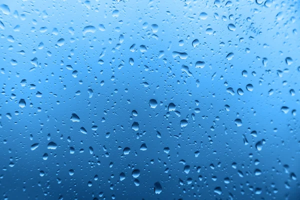 Lluvia sobre vidrio, textura de fondo — Foto de Stock