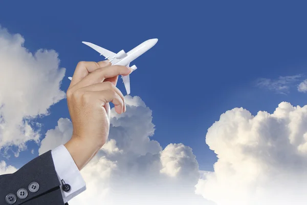Avião na mão no céu azul — Fotografia de Stock
