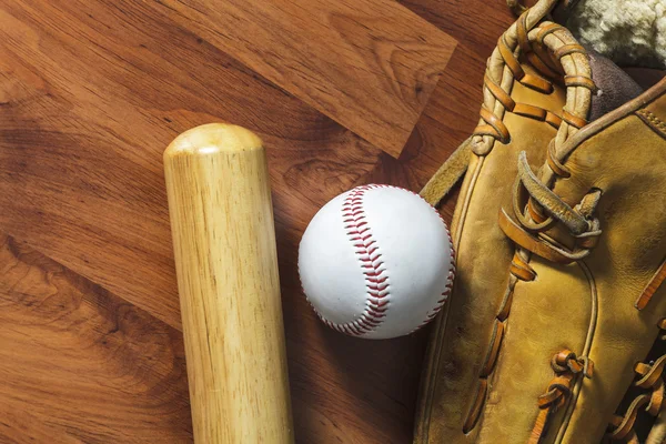 Bate de béisbol con bola y guante de béisbol sobre fondo de madera — Foto de Stock