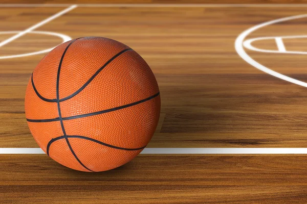 Baloncesto pelota sobre pista de baloncesto de madera dura — Foto de Stock