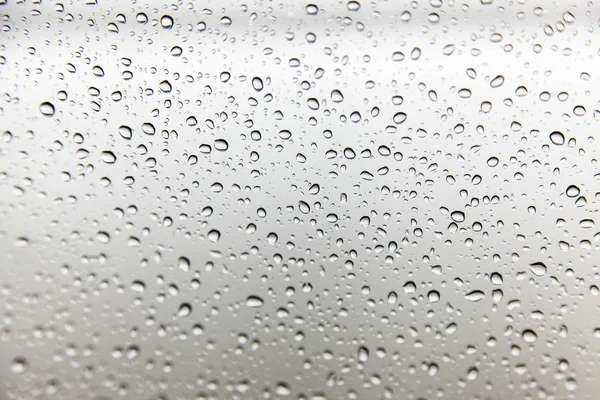Gotas de lluvia sobre fondo de vidrio —  Fotos de Stock