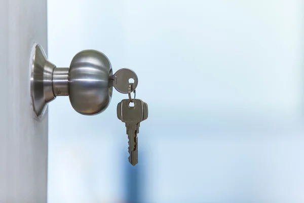 Open door with keys — Stock Photo, Image