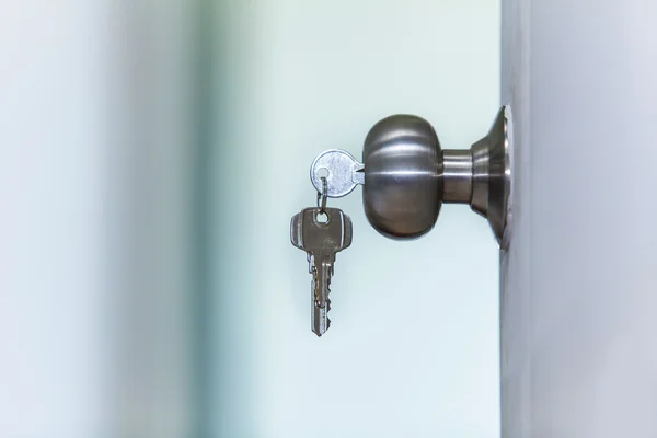 Open door with keys — Stock Photo, Image