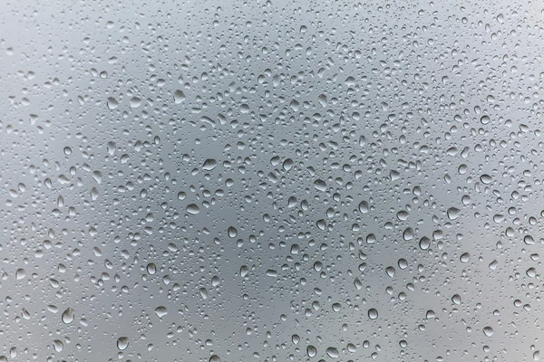 Gotas de chuva no fundo de vidro — Fotografia de Stock