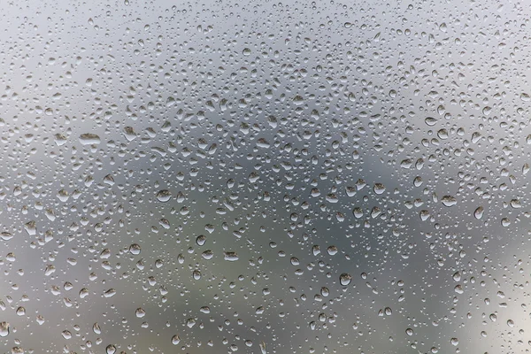 Gotas de chuva no fundo de vidro — Fotografia de Stock