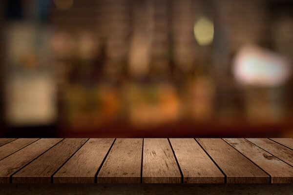 wooden table with a view of blurred beverages bar backdrop