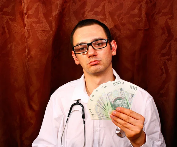 Doctor holding polish money