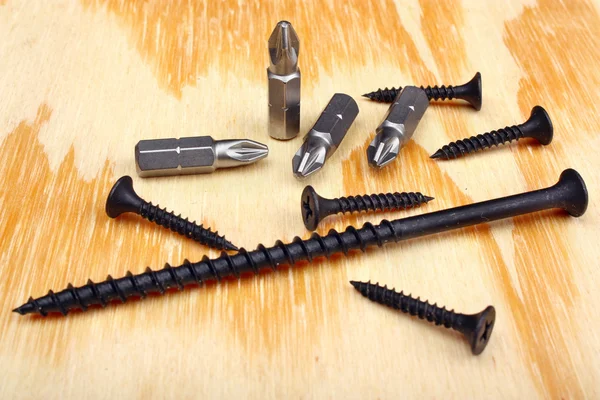 Steel screwdriver tips and screw — Stock Photo, Image