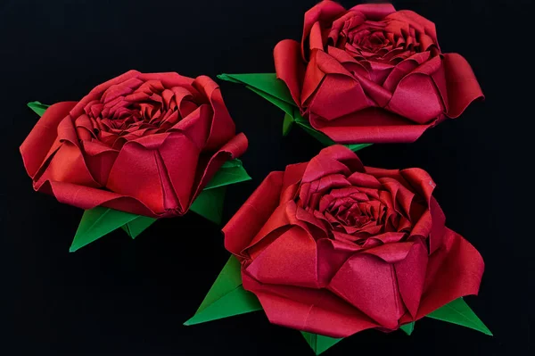 Три Красивых Оригами Красные Розы Зелеными Листьями Черном Фоне — стоковое фото