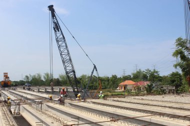 Endonezya 'da önceden gerilmiş köprü inşaatına kirişlerin yerleştirilmesi