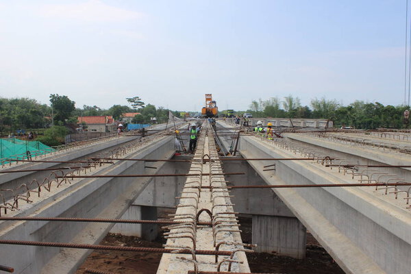 Installation of girders in prestressed bridge construction in Indonesia