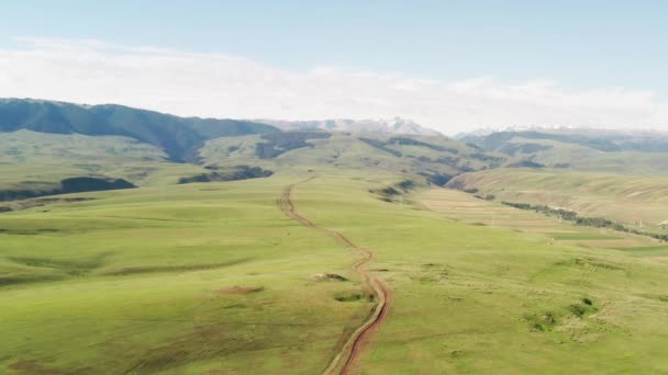 Picos de montaña y pastizales están bajo nubes blancas. — Vídeos de Stock