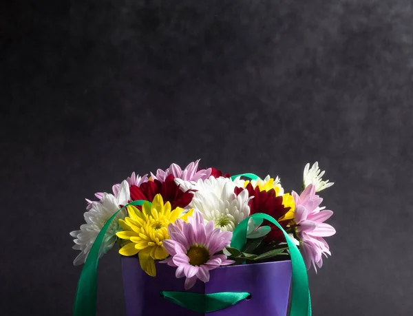 Koyu arkaplanda renkli çiçeklerle dolu güzel bir sepet. Doğum günü, yıldönümü ya da kutlama hediyesi.
