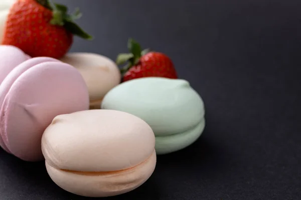 Koyu arkaplanda çilekli tatlı renkli marşmelovlar. Yakın görünüm.