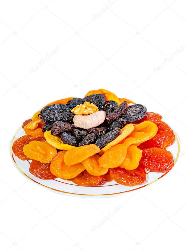 Set of dried fruits on a plate on a white background