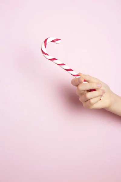 Female Hand Holding Traditional Christmas Lollipop Pink Background Classic Glossy — Stock Photo, Image