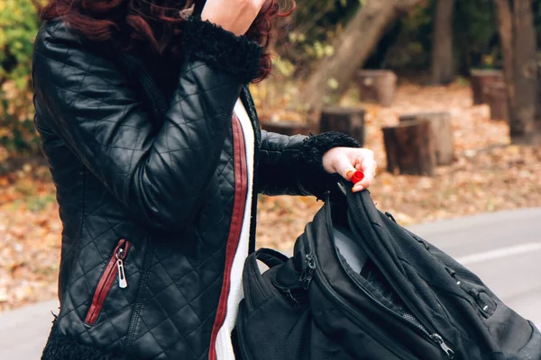 Young Woman Black Leather Jacket Puts Things Black Backpack Background — Stock Photo, Image