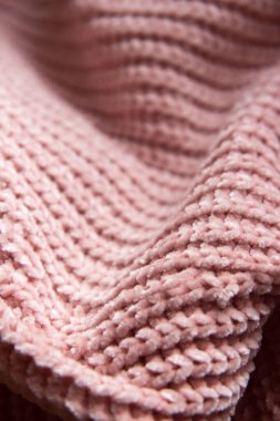 Örgü kumaşın güzel dokusu. Arka plan olarak çıplak pembe kumaş ördüm. Boşluğu kopyala
