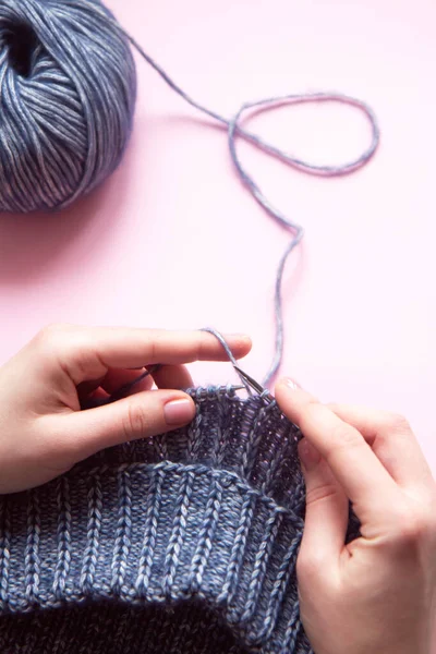 Weibliche Hände Mit Stricknadeln Stricken Wollblauen Pullover Auf Rosa Hintergrund — Stockfoto