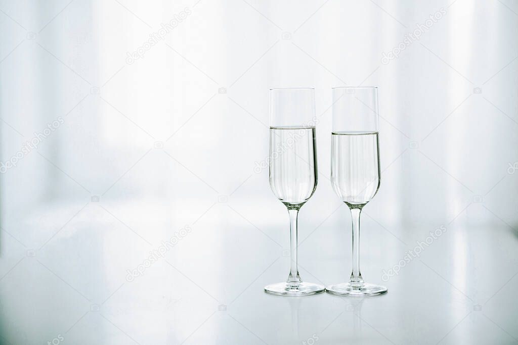 Two glasses of champagne in the background of the window