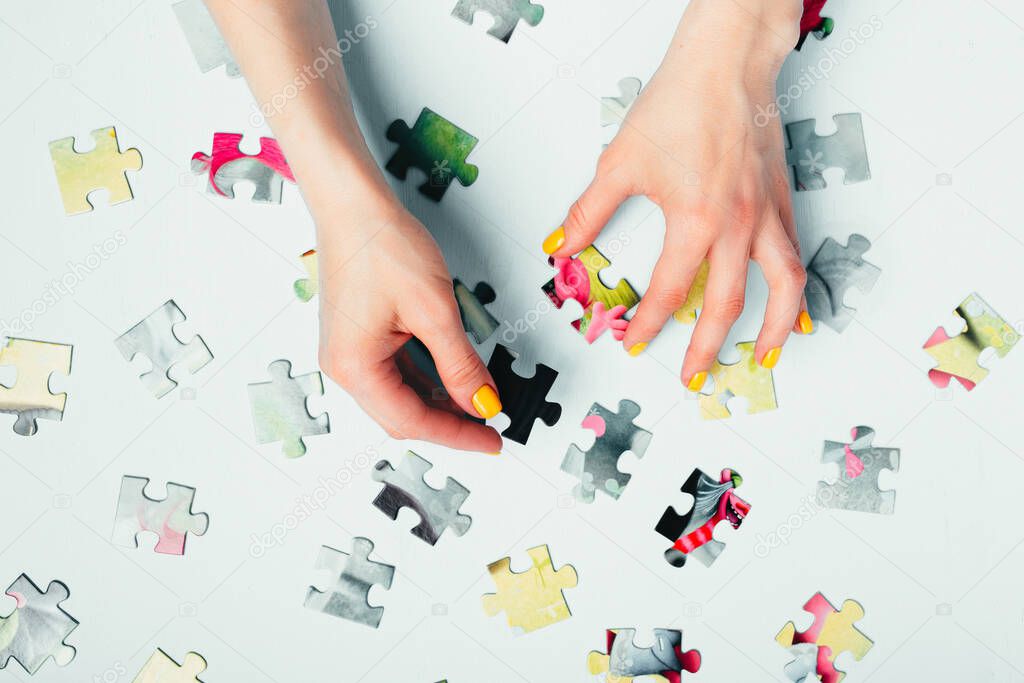 A woman collects a puzzle top view